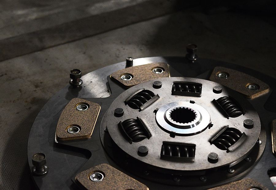 Clutch repair parts on a workshop bench